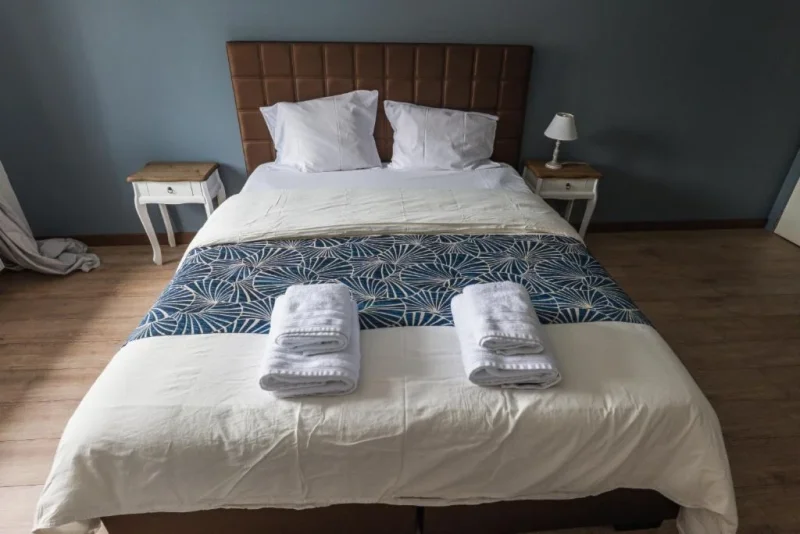 Lit double, linge blanc et tables de nuit